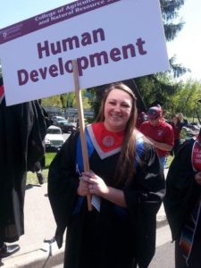 WSU graduation photo with my college sign and with WSU's mascot, Butch T. Cougar!