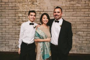 Jesse with wife and son at a wedding