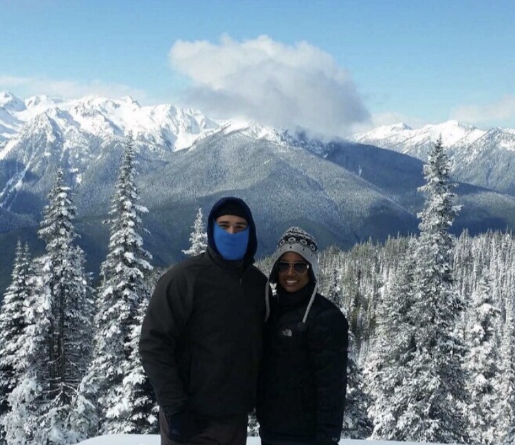Ciera with significant other in front of snow-covered trees