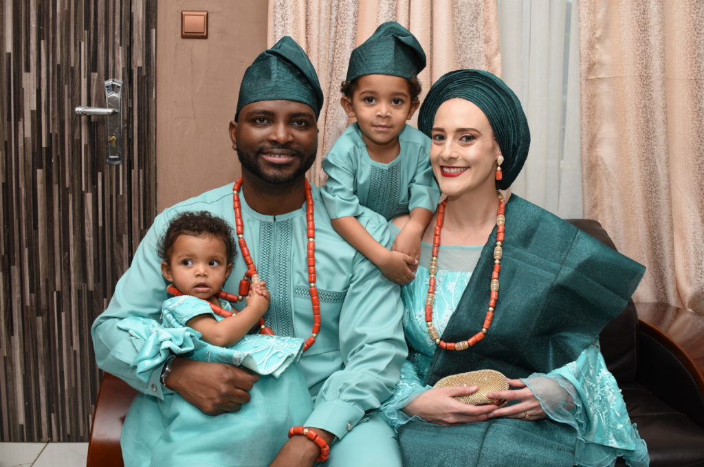 Heather with her husband and children, in traditional Nigerian attire
