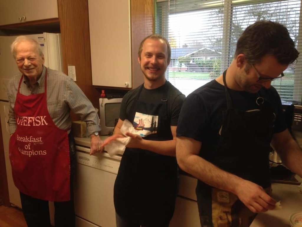 Kaleb with 2 male relatives in a kitchen